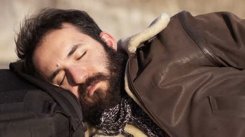 Relaxing,sleeping,sun- bearded man sleeps in the sun.