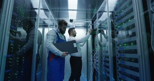 Two Men Performing Maintenance in a Data Center