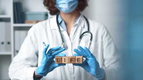 Healthcare Worker Holding Blocks Spelling Out Life