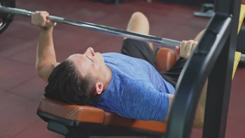 Active Caucasian Fitness trainer sportman or athlete lift up weight lifting or barbell in stadium.