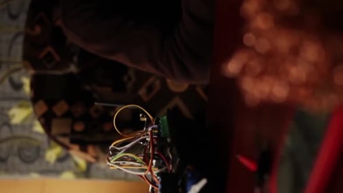 Man Uses Laptop with Electronic Components