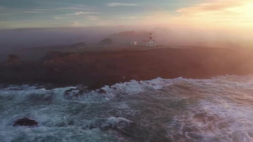 Amazing Aerial Heavenly Golden Clouds Cover Lighthouse Building at Ocean Coast