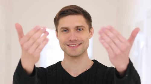 Inviting Middle Aged Man with Hands While Sitting in Office