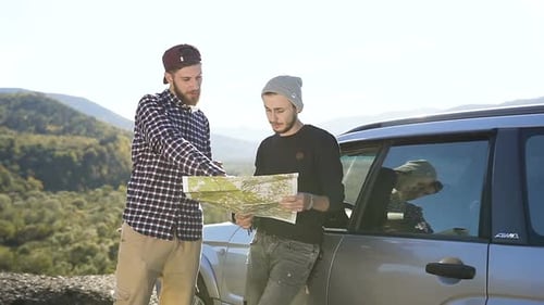 Two Friends Explore with a Road Map by Car
