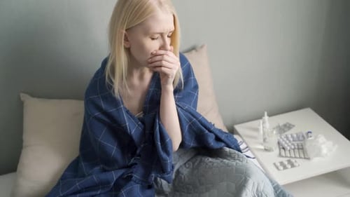 Blonde Woman Sick in Bed with a Cold