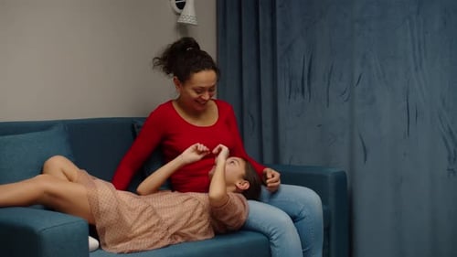 Mother and Daughter Play on the Couch