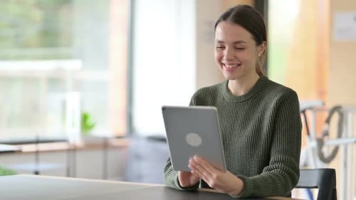 Woman Using Tablet for Video Call at Home