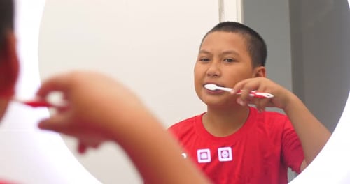 Asian Boy Brushes Teeth