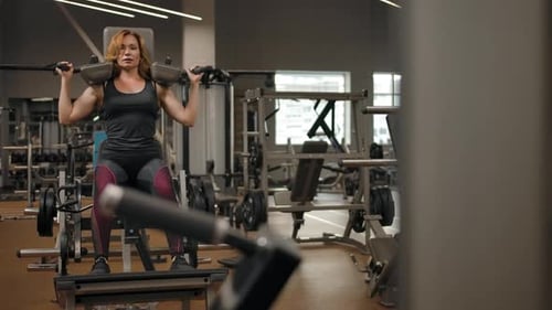 Attractive Woman Doing Strength Exercises for the Hips in the Gym