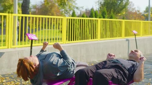 Happy Smiling Mature Senior Couple Doing Exercises of Gymnastics Together Outside