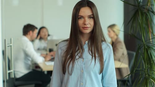 Smiling Beautiful Female Professional Manager Employee Standing in Modern Office Looking at Camera