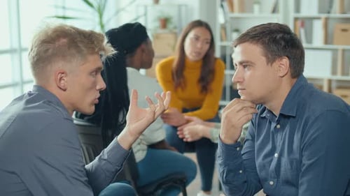 Adults Engaging in Group Discussion Indoors