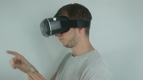 Man Wearing Virtual Reality Headset Interacting with VR