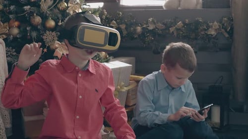 Boys Use VR Headset and Phone Near Christmas Tree