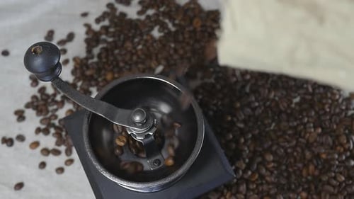 Coffee Beans Poured into Manual Grinder, Overhead View