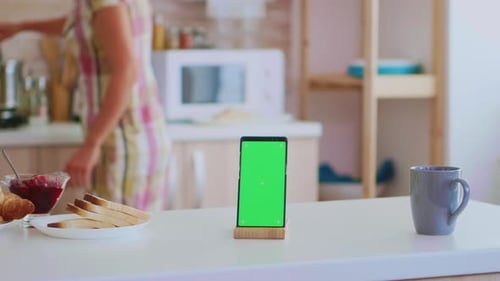 Smartphone with Green Screen in Bright Kitchen Setting