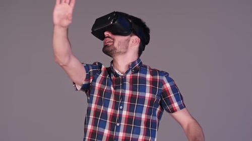 Man Wearing VR Headset Interacting with Virtual World