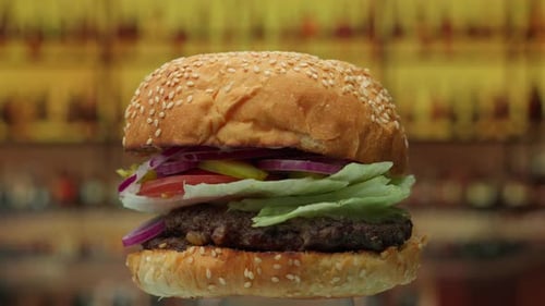 Big Burger with Beef Cutlet and Fresh Onions Rotating in Slow Motion