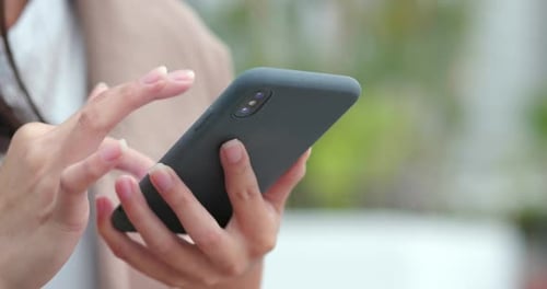 Woman Uses Smartphone in Urban Setting