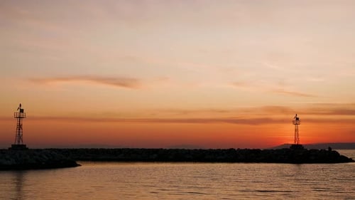 Silhouette of Lighthouses at the Entrance of the Harbor