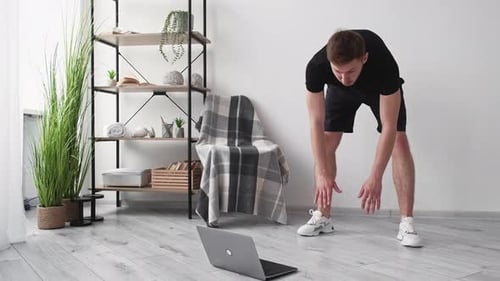 Man Performing Toe Touch Exercise at Home