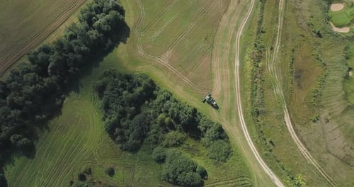 Combine Harvester on Wheat Field