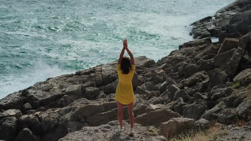 Travel at Nature Young Woman is Enjoying Sea View From Cliff