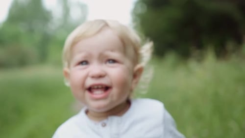 portrait of a child in the park. crying baby . parenting concept. childish tantrum and disobedience