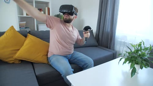Man Enjoys Virtual Reality Gaming at Home