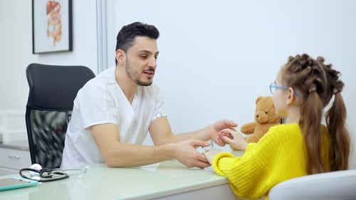 Doctor Examining Child Patient in Hospital Office