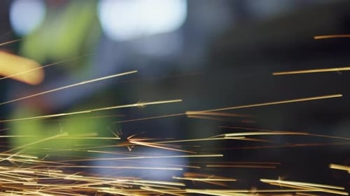 Metal Grinding with Sparks Flying in Dark Setting