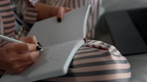 Student Writing Online Lecture at Home Closeup