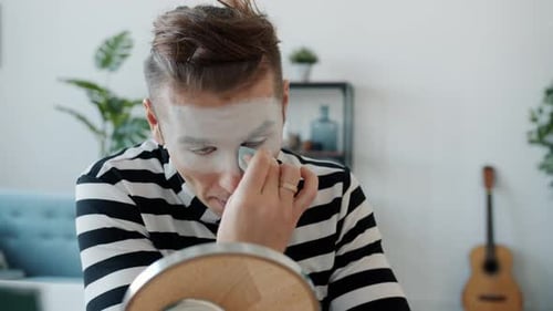 Young Adult Applying Makeup with Cosmetic Sponge