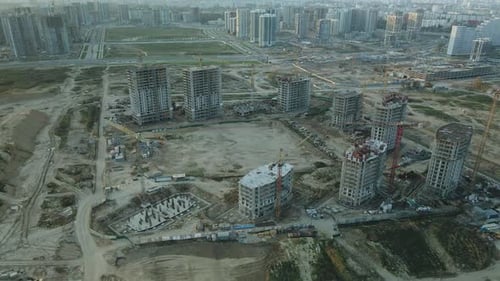 Construction site of a modern city block. High-rise buildings under construction.