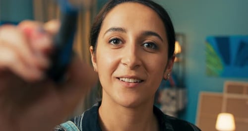 Young Adult Woman Painting in her Art Studio