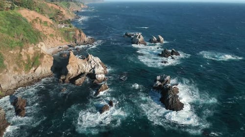 Scenic Blue Ocean Waves Crashing on the Fascinating Sharp Rocks, Summer Nature
