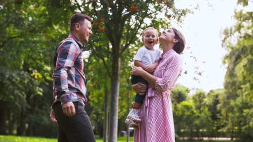 Happy Family Playing at Summer Park