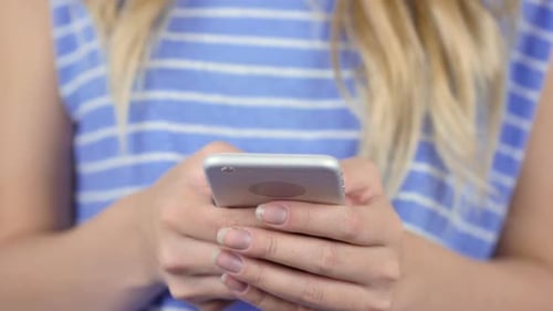 Young Adult Using Smartphone Close Up