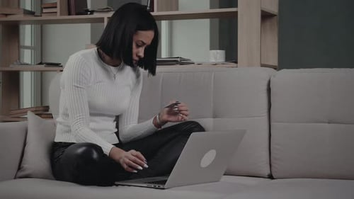 Woman Shopping Online With Credit Card On Laptop