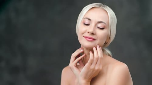 Blonde Woman Posing with Hands on Face
