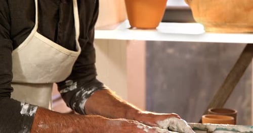 Male potter making pot in pottery workshop