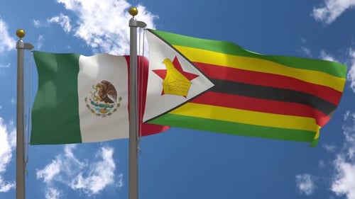 Mexico and Zimbabwe National Flags Waving Against Blue Sky