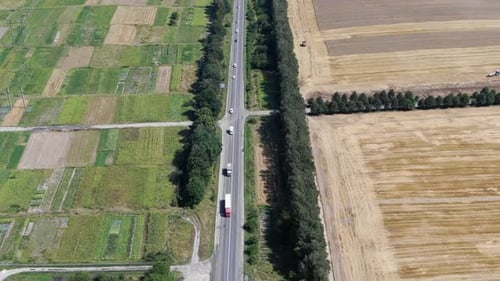 Aerial View of Road With Semi-Trucks in Rural Farmland in Ukraine