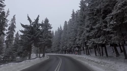 Car driving through snowy road in winter, Tatra mountains