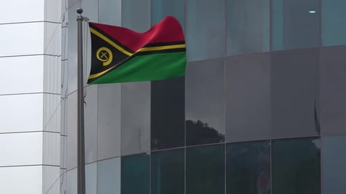 Vanuatu Flag Waving in Front of a Modern Building