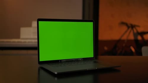 Green Chroma Key Screen on Laptop Standing on a Desk in the Living Room