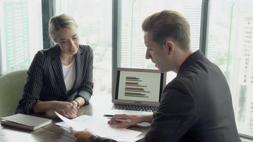 Manager meeting looking report statistic with chart and graph on screen laptop computer.