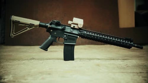 View of the Assault Rifle against the Background of Rusty Steel
