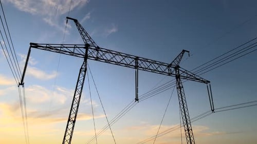 High Voltage Tower with Electric Power Lines at Sunset