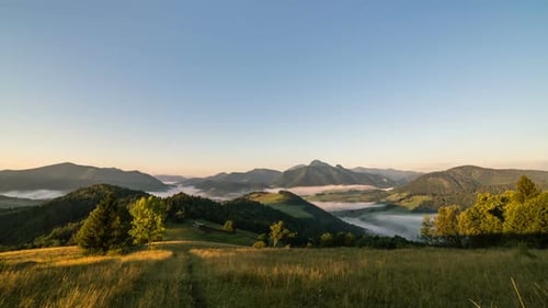 Sunrise in Summer Morning in Rural Country with Fog in Nature Landscape Valley Mountains